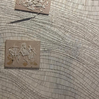 A wood art arrangement, depicting the artist's method and process of carving wood.