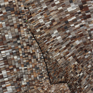 A wooden artwork created using sustainable wood materials, by an artist working for Artelier art consultancy.