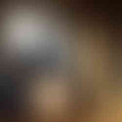 abstract wood art sculpture placed in front of contemporary wood panels in the artist's studio