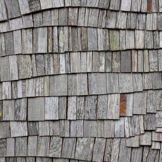 A grey natural wood sculpture, typically used as an office, hotel or bedroom feature wall.