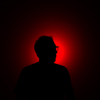 Portrait of Spanish artist SpY with red glowing background © SpY