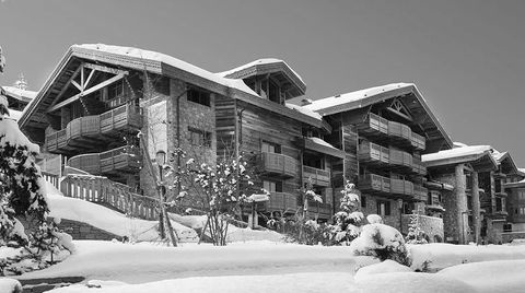 outdoor image of private chalet in courchevel, france covered in snow and made of wood
