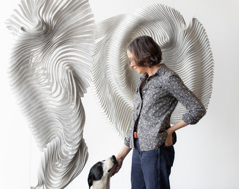 Portrait of felt artist and sculptor kristy kun at her exhibition posing iwth her dog, managed by Artelier art advisory