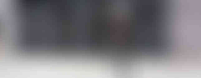 30. © 4 bronze sculpture figures emerging out of a wall in a celebratory and dancelike way