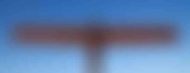 © Photo by Tom Parnell / angel of the north positioned on top of a hill in oxidised copper on a sunny day depicting an angel abstract figure with large wings