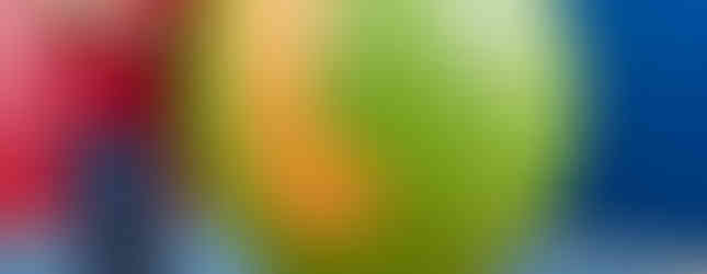 27. © Courtesy of guiness world records showing a man holding a paintbrush in a red tshirt leaning against a large ball of paint hanging from the ceiling