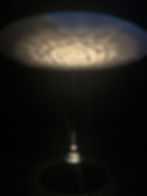 Lachlan Turczan, 'Wavespace', 2023 on display at Noor Riyadh 2023 showing a pendant light hanging over a basin of water as the ceiling shows a ripple of water like effects