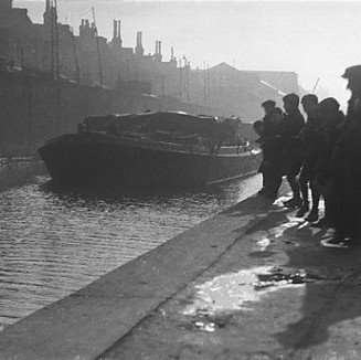 Contextual picture in black-and-white of individuals gathering on the canal in Southwark.