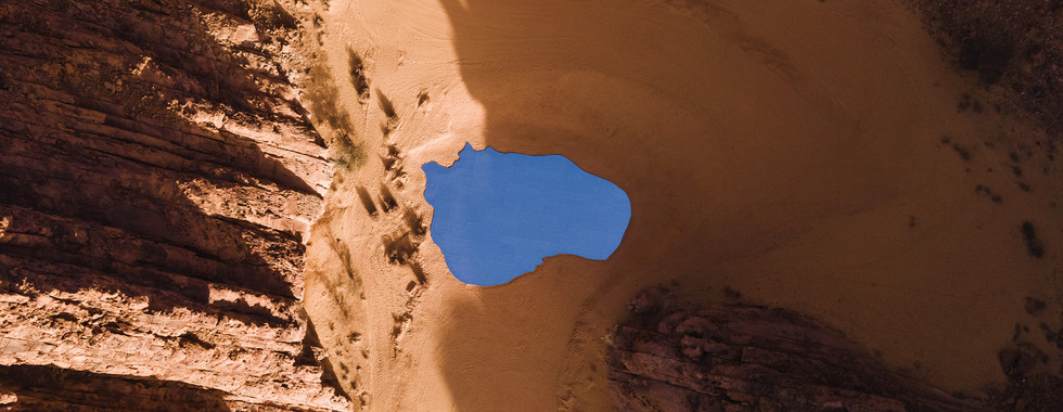 © Courtesy of Desert X, birds eye view of desert x installation in alula showing a mirror-made lake of water