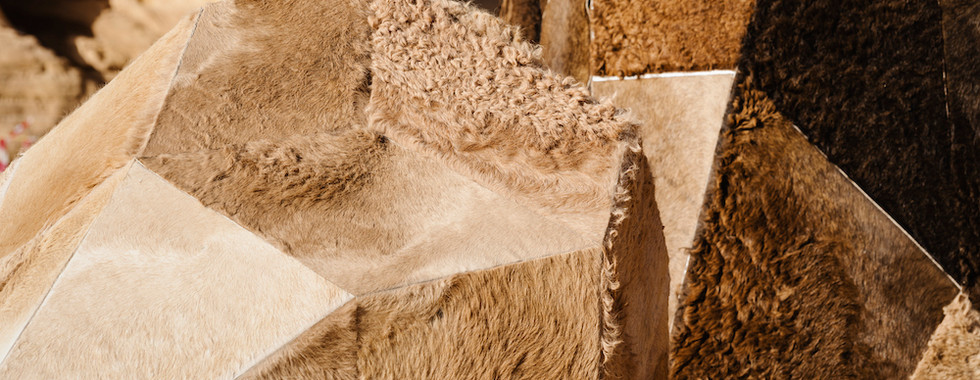 © Photo by Barbara Picci depicting 4 geometric egg style shaped large abstract contemporary art installation in the middle of desert x installation in alula made of camel hair