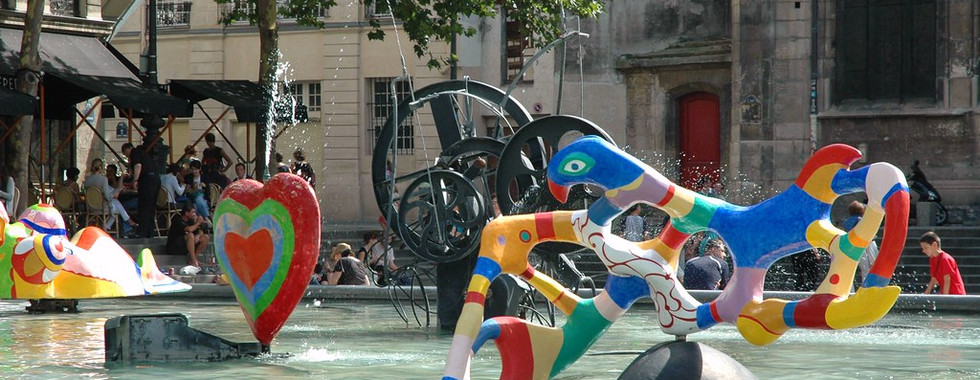 47. © Photo by Victor Fernando R. Campo showing an assortment of abstract contemporary artwork figures in rainbow colours over a water fountain the summer urban daylit space of paris