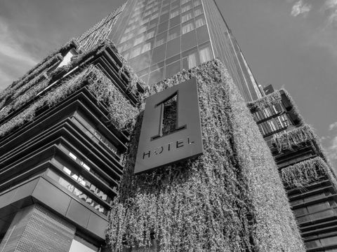 outdoor close up shot of 1 hotels organic sustainable hotel in black and white featuring a hotel tower in london