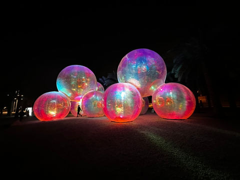 Outdoor art exhibition installation feature glowing human size bubbles at noor riyadh 2024 where artelier acted as artist liaisons