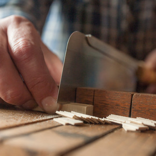 Close up Timber artist Wycliffe Stutchbury working with his hands on an art piece in his UK-based studio