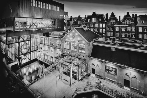 black and white night image of andaz by marcel wander's boutique hotel in amsterdam, netherlands
