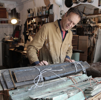 Timber artist Wycliffe Stutchbury working with his hands on an art piece in his UK-based studio