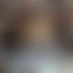 Timber artist Wycliffe Stutchbury working with his hands on an art piece in his UK-based studio