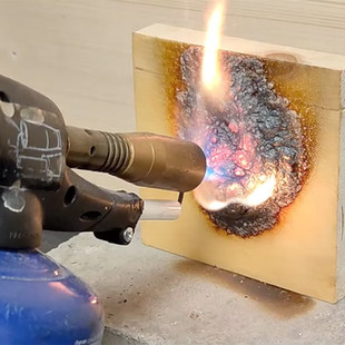 Testing fire resistance in the workshop on a piece of timber before using the final products for a bespoke, personalised feature wall for bombardier global 500 project by Artelier