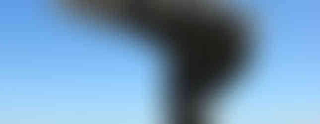 © Photo by Colin Gould, showing contemporary art sculpture on top of the hills in britain on a sunny day showing a wave like motion positioning of metal pipes