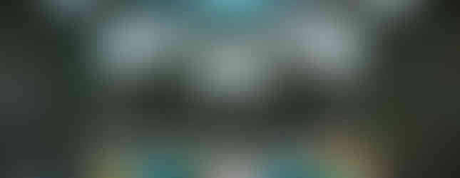 48. © Photo by Martin Heimburger showing the interior of a period building with a dome-like architecture with green steel infrastructure and large glass panel ceilings in daylight with an array of multicoloured circle shaped glass domes at the bottom on the floor