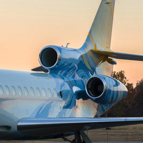 Exterior of private jet with a backdrop of the sunset. Inspired by the artistry of Van Gogh, the exterior of this incredibly unique Dassault Falcon 7X is taken from his timeless masterpiece, 'The Starry Night' © Designed by Winch Design and completed at Dassault Falcon