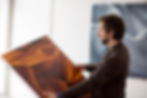 artist holding his own work commissioned by artelier