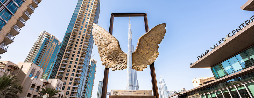 22. © Courtesy of Timeout showing a pair of gold wings perfectly in line with the tallest building in Dubai