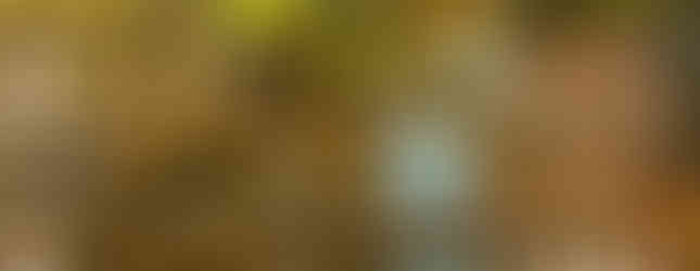 © Photo by William Cho of an abstract human figure made out of metal shot at night in an urban space as it sits above water with a stone slab bridge next to it