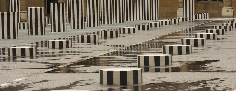 46. © Photo by Thierry via Flickr showing a liner assortment of black and white stripe cylinders of varying heights in the rain in the middle of an outdoor space