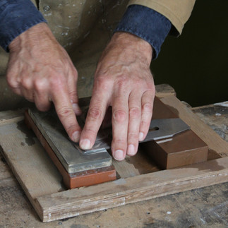 Timber artist Wycliffe Stutchbury working with his hands on an art piece in his UK-based studio