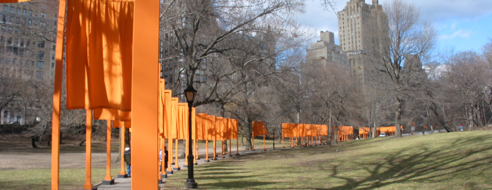 38. © Photo by Dennis Yang showing a line of orange draped flags hanging over a new york based park park