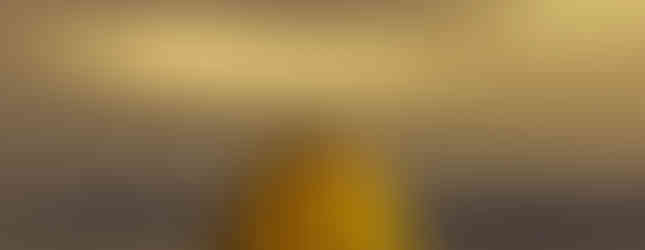 57. © Photo by Alex Stoen showing a contemporary art installation of a yellow dotted squash pumpkin shape overlooked a lake in japan in the evening