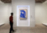 man looking at artwork in a contemporary art exhibition