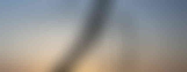 © Photo courtesy of Architects Journal / interwined steep structures standing over 110 feet tall in Middlesbrough in a sunset landscape