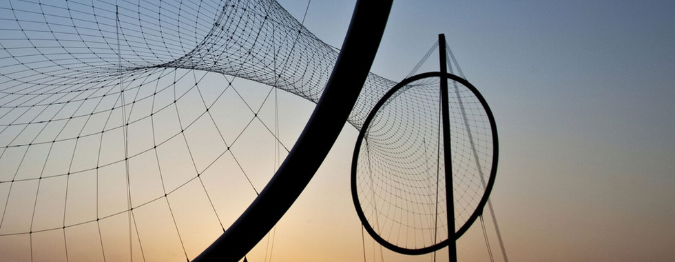 © Photo courtesy of Architects Journal / interwined steep structures standing over 110 feet tall in Middlesbrough in a sunset landscape