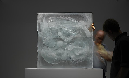 an example of Logistics & Installation in action by artelier art consultancy featuring danny lane the glass sculptor and his assistance installation a cube / square / block abstract glass sculpture