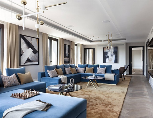 in a luxury sitting room leisure space with velvet blue chairs and mid century chandeliers, commissioned abstract black and white contemporary canvas in rothko style by artelier art advisors for chelsea barracks residential scheme in london