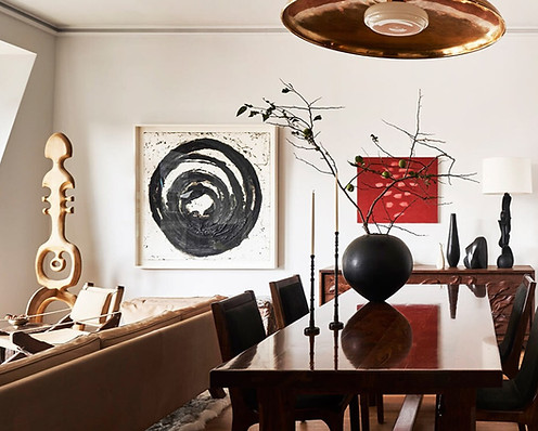 London art curation using art advisory services, including a wodden sculpture, a square canvas piece with circular black paint