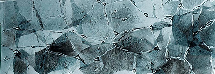 glass artwork in a rhombus form, with dark blue detail inside.