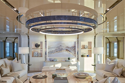 example of art logisitics and installation by aurora borealis in the open reception of a large scale yacht with a mountain abstract feature wall piece in golds and creams