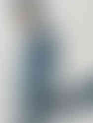 This fine art to invest in piece by Emilia Momen is of a middle-aged man walking down the street, wearing a blue tuxedo and aviator sunglasses that cover most of his face. Background is white and shadow is prominent.