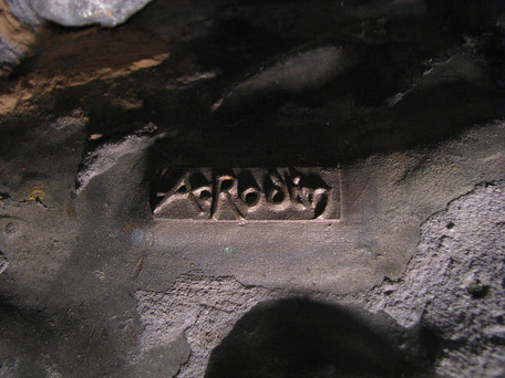 A close-up detail of famous public art: Rodin's 'The Thinker'. Closeup shows Rodin's signature, embedded into the bronze sculpture cast.