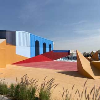 Brightly coloured and contrasting geometric paint on a cityscape, with the sky above. photographed by Artelier's public art consultants