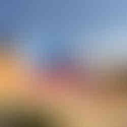 Brightly coloured and contrasting geometric paint on a cityscape, with the sky above. photographed by Artelier's public art consultants