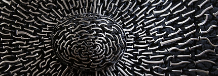 black and white metal wire artwork with the white details lit up in multitudes by light.