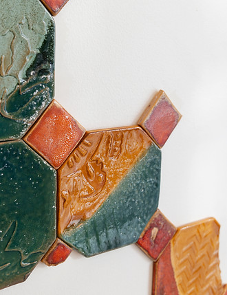 up close detailed shot tiled ceramic fragmented wall piece for raffles hotel oasis palace, bahrain, commissioned by artelier inspired by ancient traces of the dilmun past. Curated next to the reception desk