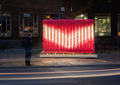 giles miller red fluorescent bulb display at night in london