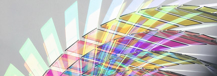 dynamic glass artwork depicting a range of hues in a circular form with multiple glass pieces.