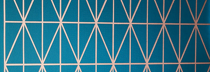 teal feature wall with gold geometric lines (diamond-shape), set inbetween two marble slabs against a grey wall