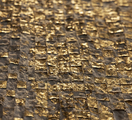 up close detail shot of an artwork commissioned by artelier art curatin services for raffles hotel in bahrain featuring gold leafed textiled squares layered 